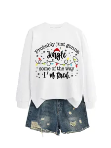 Close-up details of the white long-sleeve Christmas graphic sweatshirt paired with shorts.