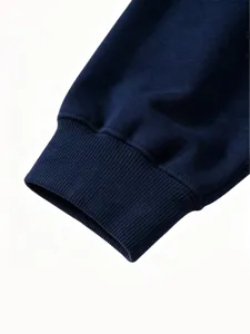 Kids solid color sweatshirt detail shot, showing elastic ribbed cuff and soft fabric texture.