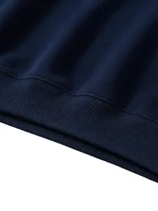Navy blue sweatshirt ribbed hem detail, soft knit fabric texture, casual kids clothing close-up.