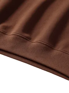 Brown sweatshirt detail shot highlighting the soft ribbed hem and fine stitching quality.