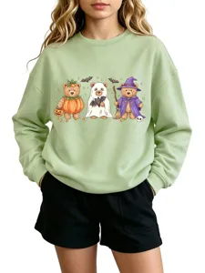 Close-up detail of the cute Halloween teddy bear graphic on the mint green crewneck sweatshirt.