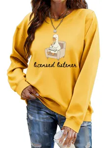 Detail view of the yellow cotton sweatshirt showcasing the cute reading duck graphic print.
