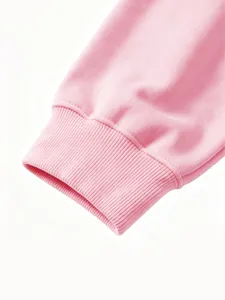Pink kids sweatshirt ribbed cuff detail close-up, soft knit fabric texture, cozy children apparel.