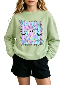 Cute pastel ghost graphic detail on light green crewneck sweatshirt, cozy autumn children's wear.
