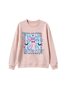 Detailed view of a cute pastel iridescent bow ghost graphic on a pink cozy sweatshirt.