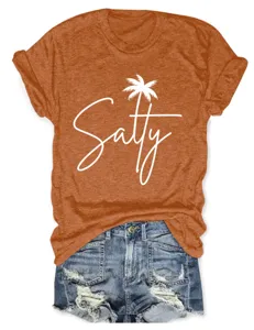 Close-up detail of the orange short-sleeve t-shirt featuring a white salty palm tree print.