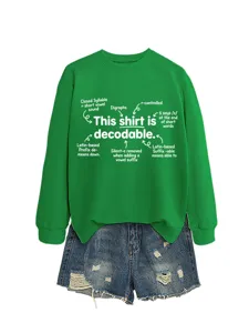 Green crewneck sweatshirt featuring educational linguistic text paired with denim shorts.