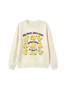 Close-up detail of cute cartoon yellow ducks print on soft beige crewneck sweatshirt
