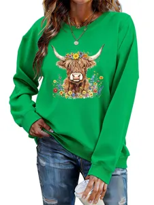Detailed view of the green sweatshirt with cute highland cow and colorful floral print.