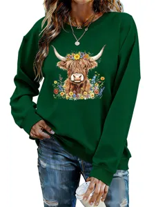 Detail view of casual green long sleeve sweatshirt featuring a cute floral highland cow graphic.