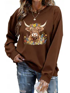 Close-up detail of the brown women sweatshirt featuring floral highland cow graphic.
