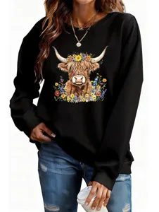 Close-up detail of the floral highland cow graphic print and soft black sweatshirt fabric.