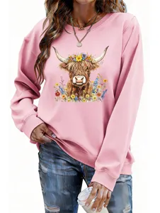 Detailed view of women pink long sleeve sweatshirt with cute highland cow and colorful floral print.