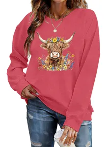 Close-up detail of a red women's sweatshirt featuring a cute highland cow floral print.