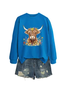 Women blue long sleeve sweatshirt with cute highland cow floral print paired with denim shorts.