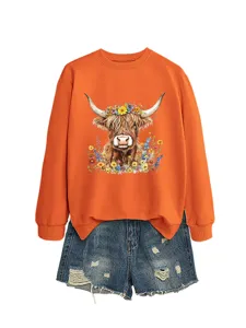 Casual women's orange long sleeve sweatshirt with cute Highland cow and floral graphic detail.