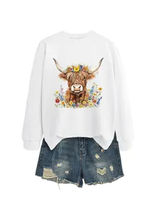 Detailed view of the white sweatshirt featuring a cute floral highland cow graphic print.