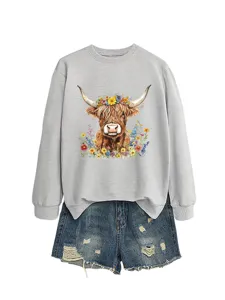 Casual women grey crewneck sweatshirt featuring cute highland cow floral graphic and denim shorts.