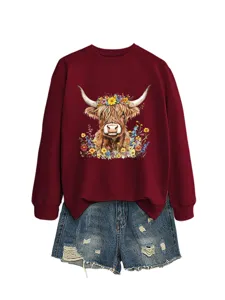 Maroon sweatshirt featuring a highland cow floral graphic paired with distressed denim shorts.