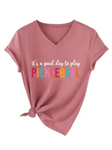 Detailed shot of the pink V-neck t-shirt featuring playful pickleball typography and knot hem.