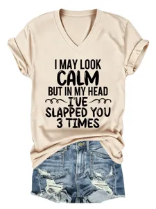 Casual beige V-neck short sleeve tee with funny slogan print and distressed denim shorts.