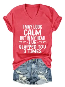 Detailed view of the red V-neck short sleeve t-shirt with funny quote text and denim shorts.