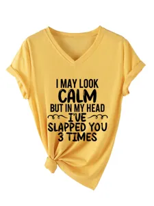Close-up of yellow V-neck short sleeve T-shirt with funny text print and front knot detail.