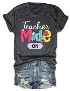 Women short sleeve t-shirt casual teacher mode graphic tee with distressed denim shorts.