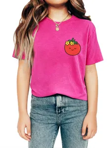 Close-up view of cute kids pink crewneck t-shirt featuring sweet tomato chest graphic print.