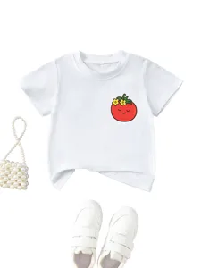 Close-up detail of cute tomato floral print kids white t-shirt paired with pearls and shoes.