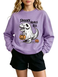 Detail view of the spooky saurus rex graphic print on the cozy purple kids sweatshirt.