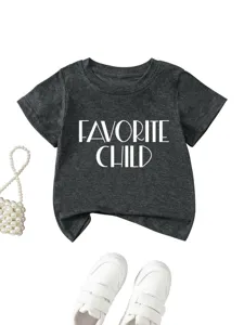 Detail view of dark gray toddler t-shirt featuring bold text print and matching white shoes.
