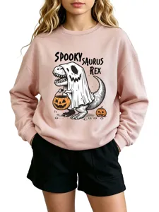 Close-up view of the light pink crewneck sweatshirt featuring a fun Halloween dinosaur print.