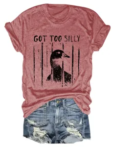 Close-up detail of casual red heather graphic t-shirt featuring funny duck print and denim shorts.