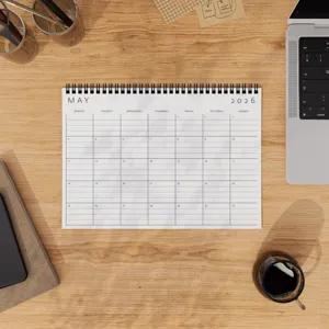 Detailed flat lay shot of a May 2026 monthly calendar planner on wooden desk with office items.