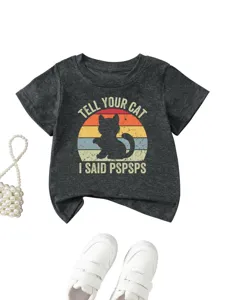 Cute cat graphic detail on dark gray kids t-shirt, retro sunset print, soft fabric close-up