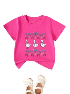 Pink kids short sleeve t-shirt detail with cute duck print and matching white shoes display.