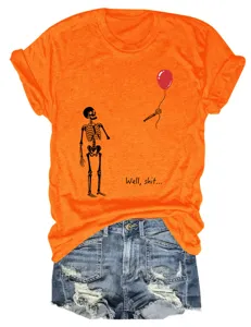 Close-up detail of the vibrant orange graphic skeleton t-shirt with funny quote text.