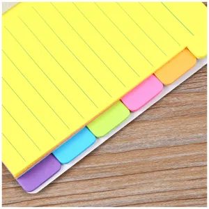 Colorful index sticky notes detail, neon yellow memo pad with multi-color tabs for study.