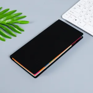Black index sticky notes notepad close up detail view with colorful tabs on desk