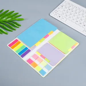 Detailed view of colorful sticky notes set with index tabs on a clean grey desk.