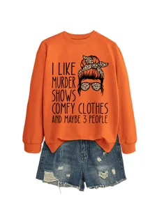 Close-up of casual orange long sleeve sweatshirt with funny text print and denim shorts.