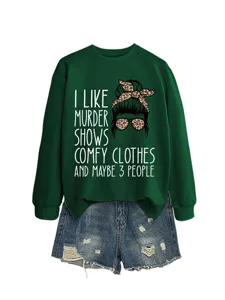 Detailed view of the dark green graphic sweatshirt with funny text and stylish denim shorts.