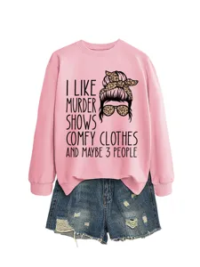 Women casual long sleeve pink sweatshirt paired with distressed denim shorts, fun graphic print.
