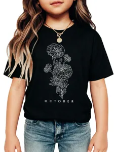 Close-up detail of children's black t-shirt featuring white floral graphic and text.