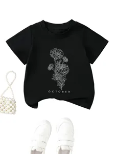Children's black t-shirt detail featuring floral line art and october graphic print.