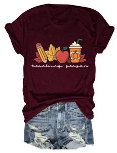 Women's burgundy short sleeve t-shirt with autumn teacher graphic and denim shorts set.