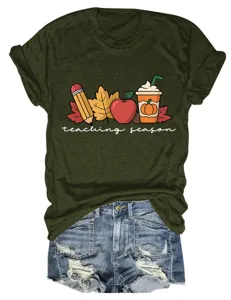 Close-up detail of the olive green t-shirt featuring fall themed graphic print and text.