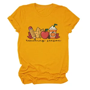Close-up view of the golden yellow short sleeve t-shirt featuring a cute autumn teaching graphic.