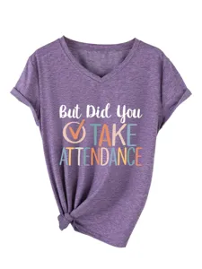 Close up of purple V-neck short sleeve t-shirt detail showing chest letter print and tied hem.